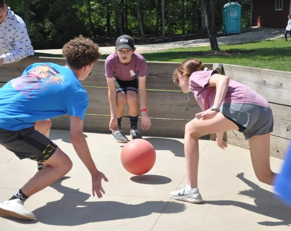 a group of people playing basketball