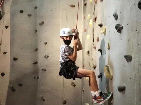 a person climbing a rock wall