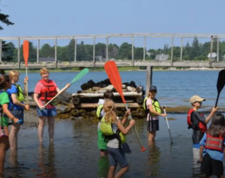 a group of people holding paddles