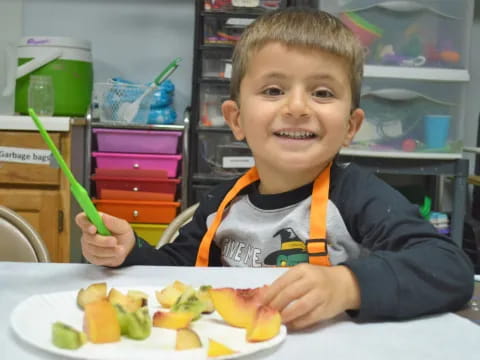 a boy eating a fruit