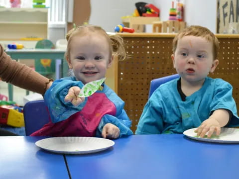 a couple of kids eating cake
