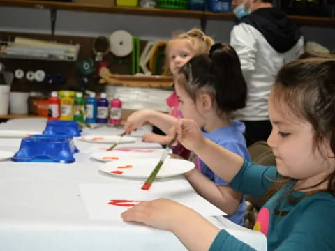 a group of children painting