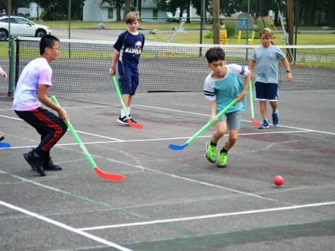 a group of kids playing hockey