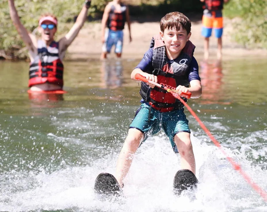 a couple of people water skiing