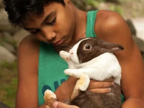 a person holding a small animal