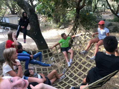 a group of people sitting on a bench in a park