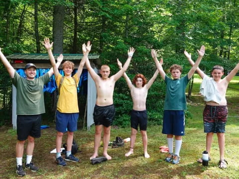 a group of people posing for a photo in front of trees