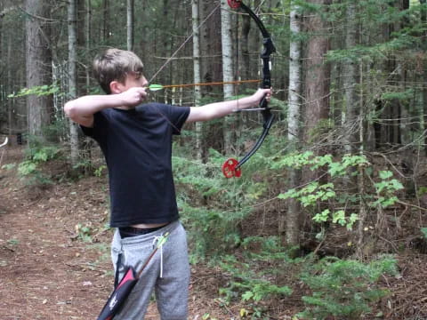 a boy holding a bow and arrow