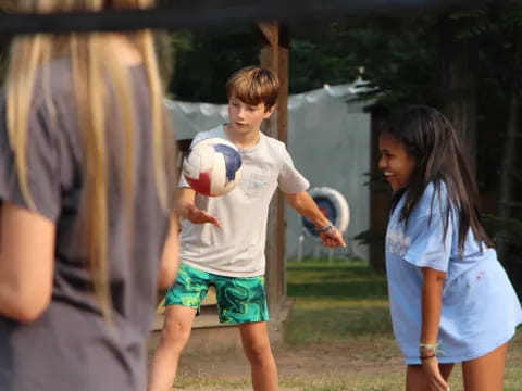 a boy holding a football ball