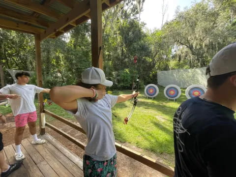 a group of people playing with bows and arrows