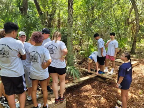 a group of people standing in a forest