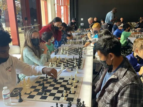 a group of people playing chess