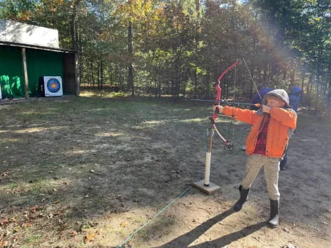 a boy holding a bow and arrow