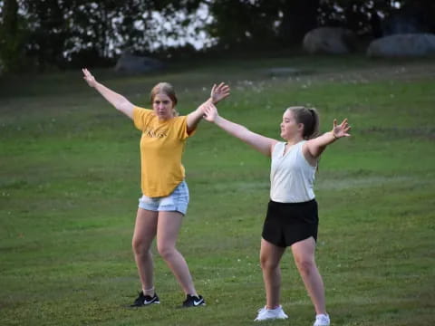 two women in a grassy field