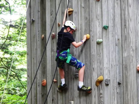 a person climbing a wooden wall