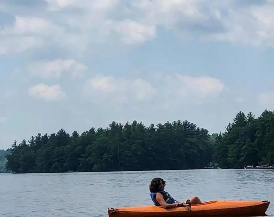 a person in a canoe on a lake
