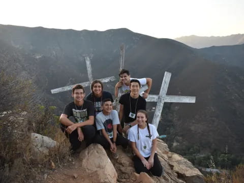 a group of men posing on a rock