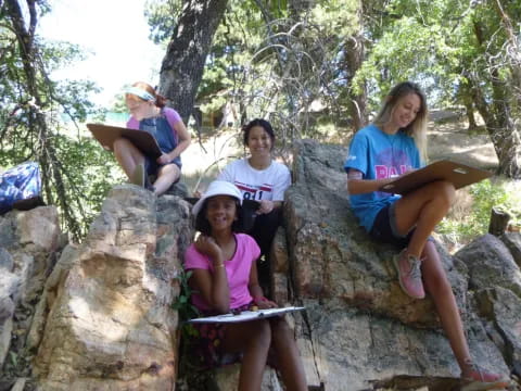 a group of people sitting on rocks