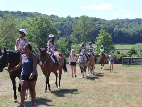 a group of people riding horses