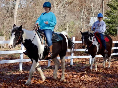 a couple of people riding horses