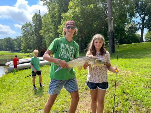 a man and a woman holding a fish