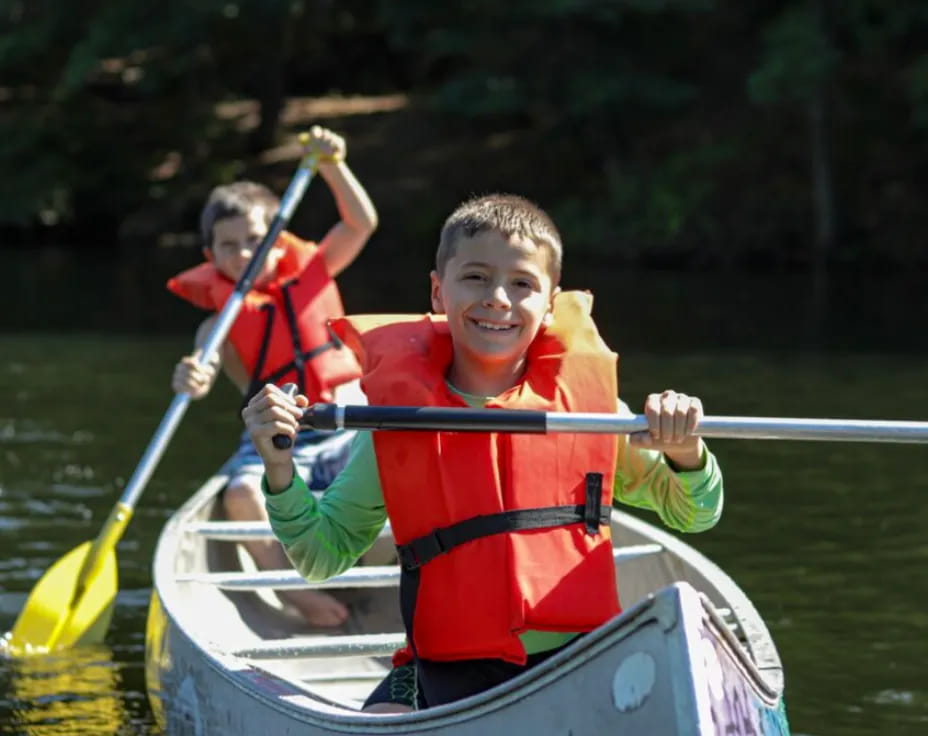 a group of people in a canoe