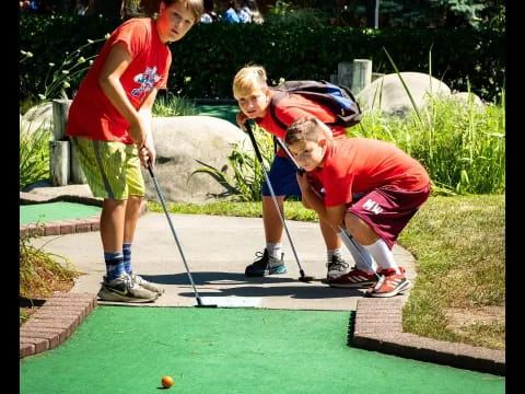 a couple of kids playing golf