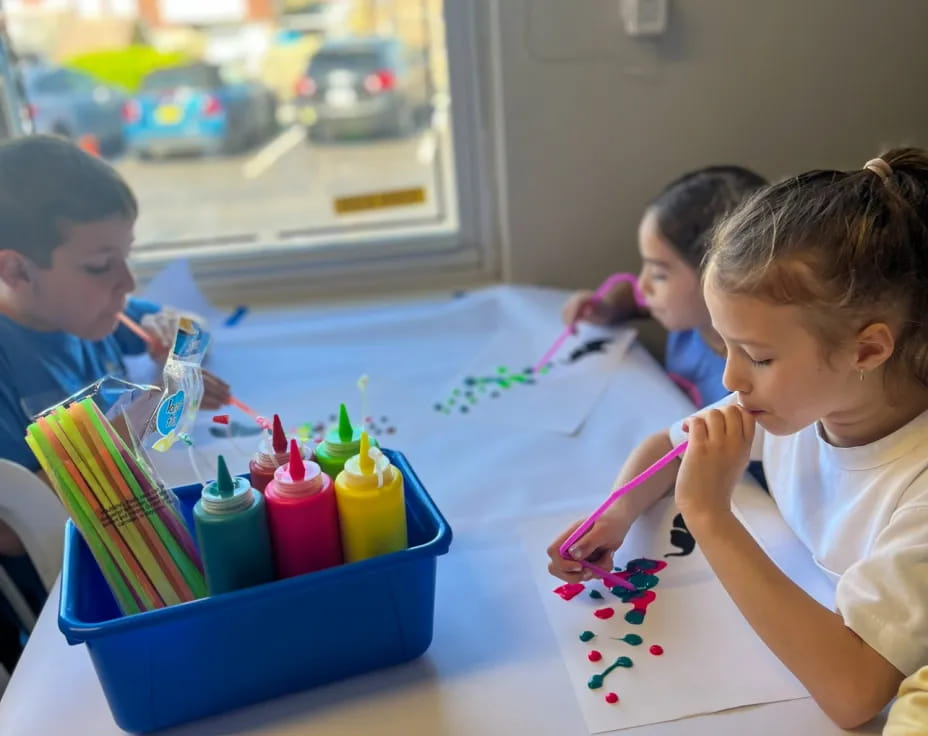 children painting on a table