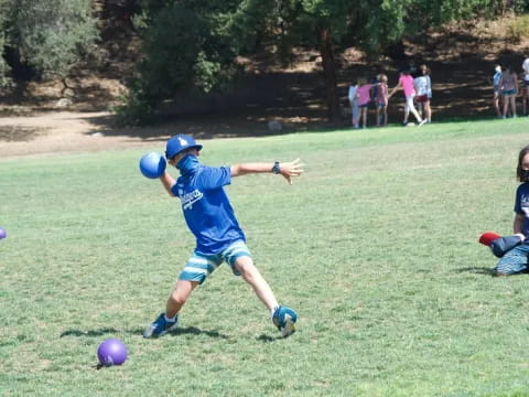 a kid playing with a ball
