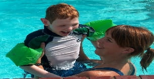 a couple of kids in a pool