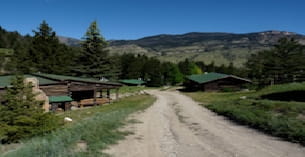 a dirt road leading to a small village