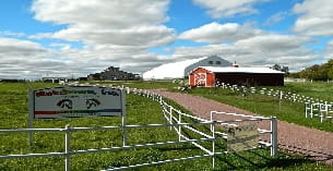 a farm with a sign