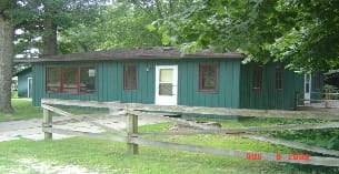 a green house with a fence
