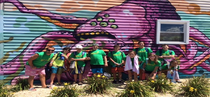 a group of people posing for a photo in front of a tent