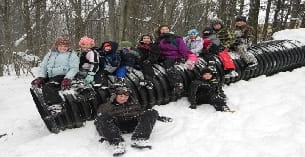 a group of people sitting in the snow