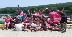 a group of people sitting on a beach
