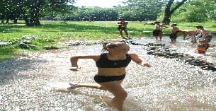 a man running through a muddy area