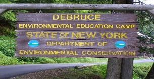 a sign on a wooden fence