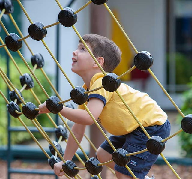 a boy playing with a bow and arrow