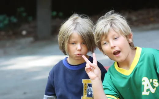 two children making hand gestures