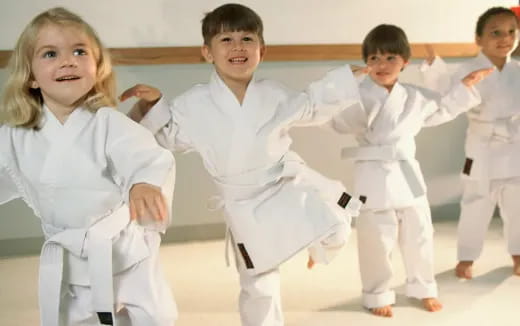 a group of children in karate uniforms