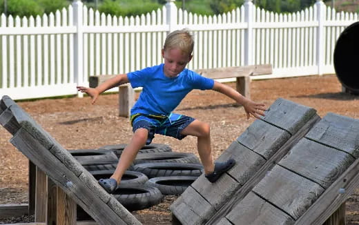 a boy playing on a playground