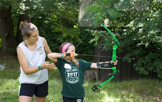 a couple of women shooting bows