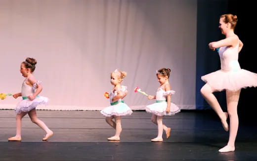 a group of girls performing on stage