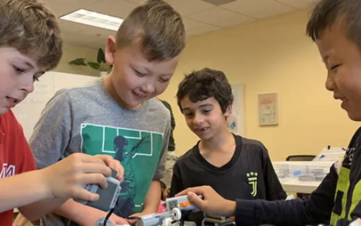 a group of boys looking at a device