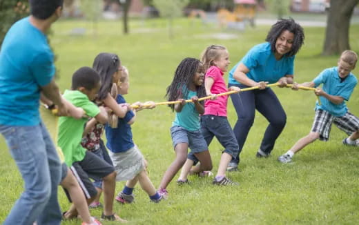 a group of people playing with sticks