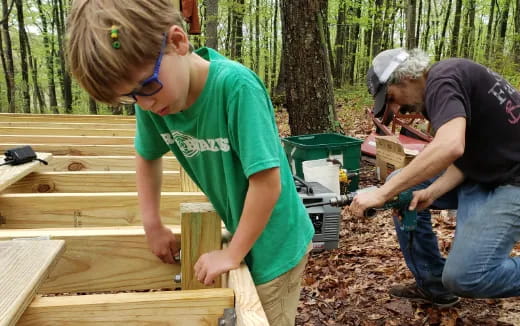 a couple of people building a structure