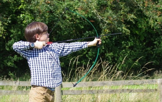 a boy shooting a bow