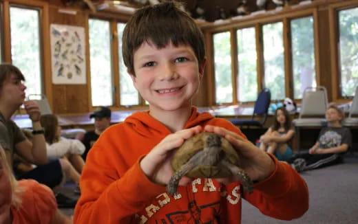 a boy holding a snake