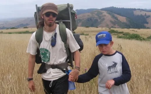 a man and a woman walking in a field